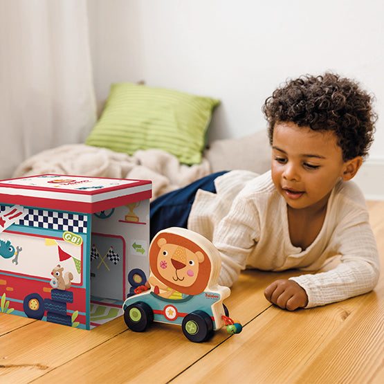 Lion Bababoo Push and Pull Toy lifestyle image with child and interactive packaging